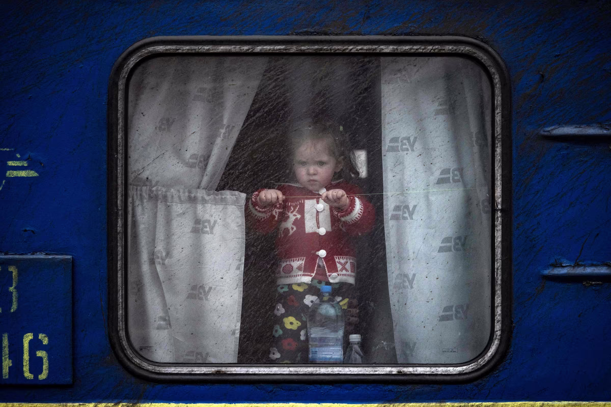 A child appears in the window of a train at Kramatorsk central station as families flee Kramatorsk.