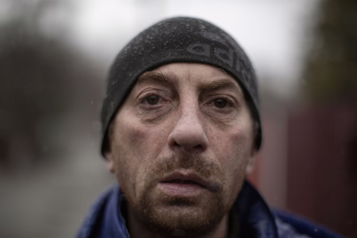 A civilian weeps while speaking of being beaten by Russian soldiers in Vorzel near Bucha.